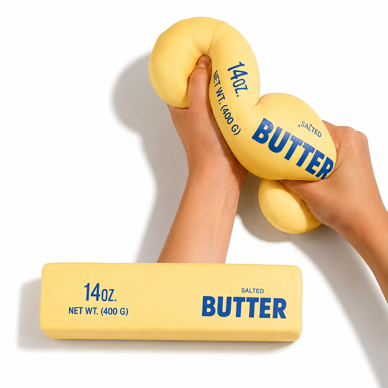 Giant Butter Stick Squishy being squeezed and stretched by two hands, showing its moldable texture
